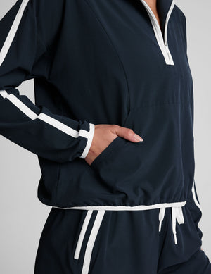 blue pullover with a half zip front​ and front kangaroo pocket​. 