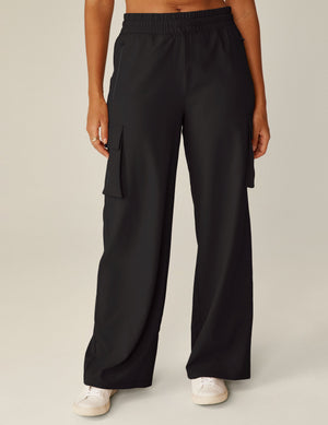 Front view of black City Chic Cargo Pant with wide legs, side flap pockets, and a gathered elastic waistband.