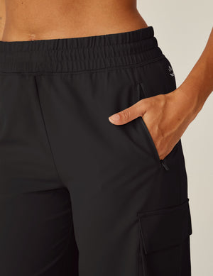 Close-up of the City Chic Cargo Pant in black, featuring an elastic waistband, zipper pocket, and side cargo flap pocket.