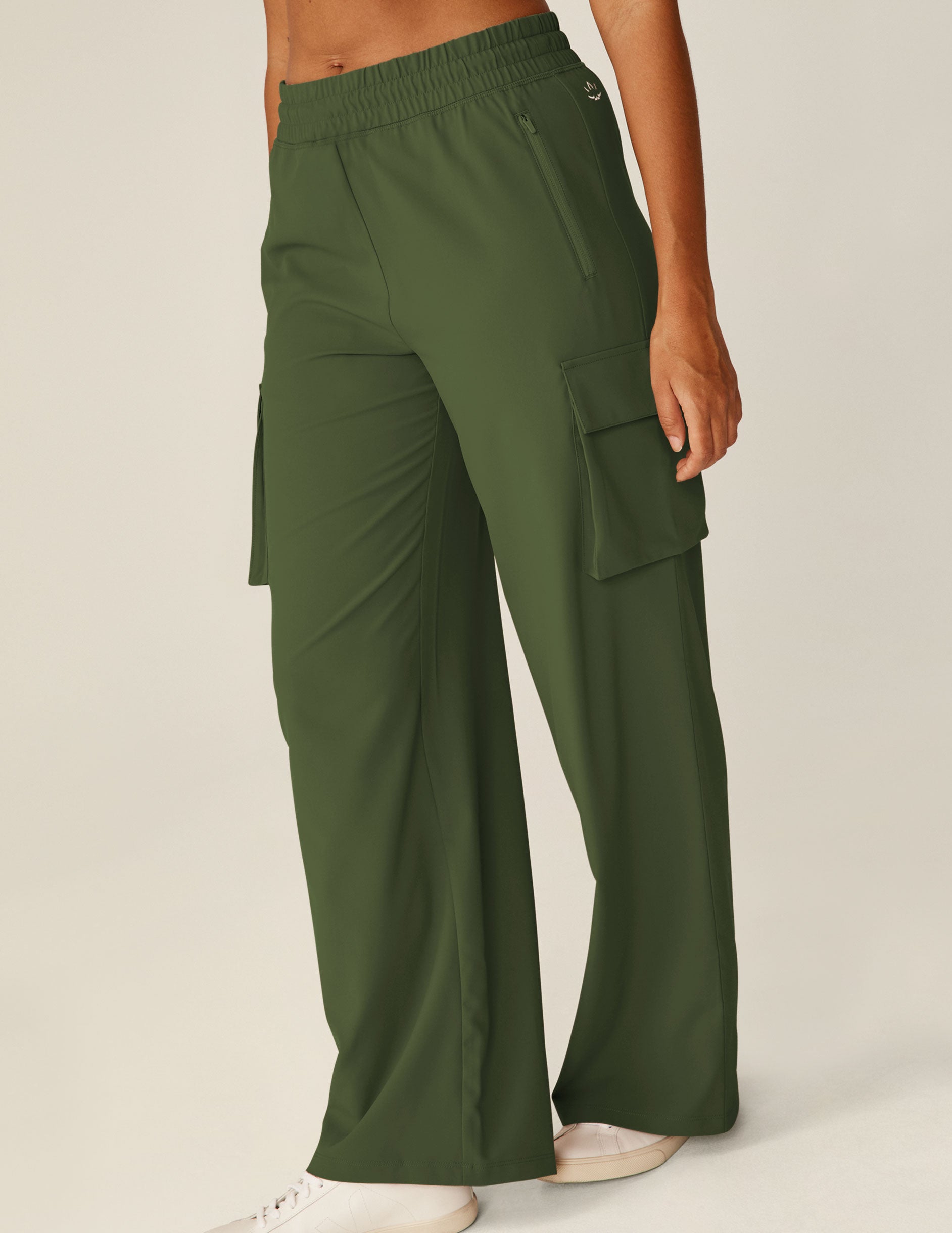green jetstretch pants with cargo style pockets on the side of each leg.