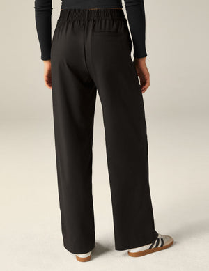 Rear view of black Status Wide Leg Trousers showing the elasticated back waistband, belt loops, and a back welt pocket.