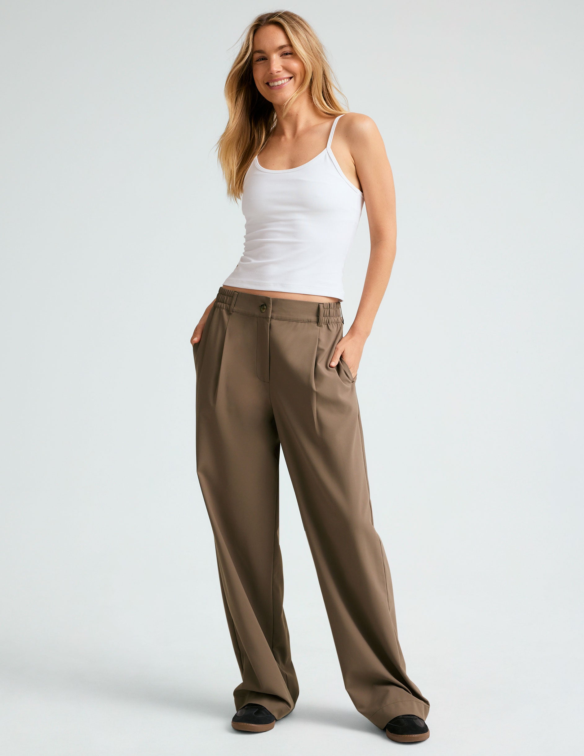 brown mid rise jetstretch woven pants with cargo style pockets.