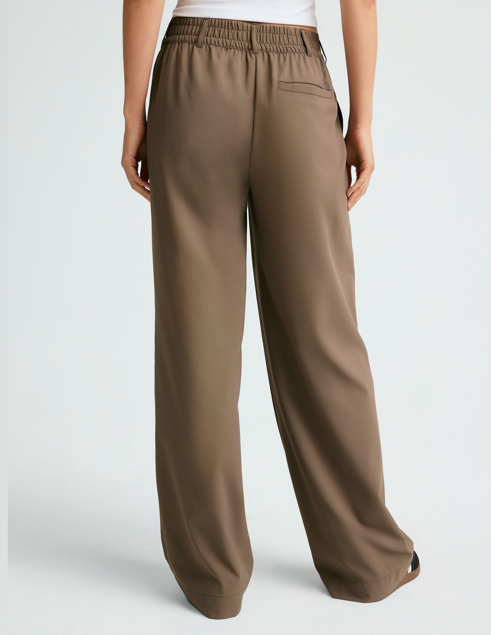 brown mid rise jetstretch woven pants with cargo style pockets.