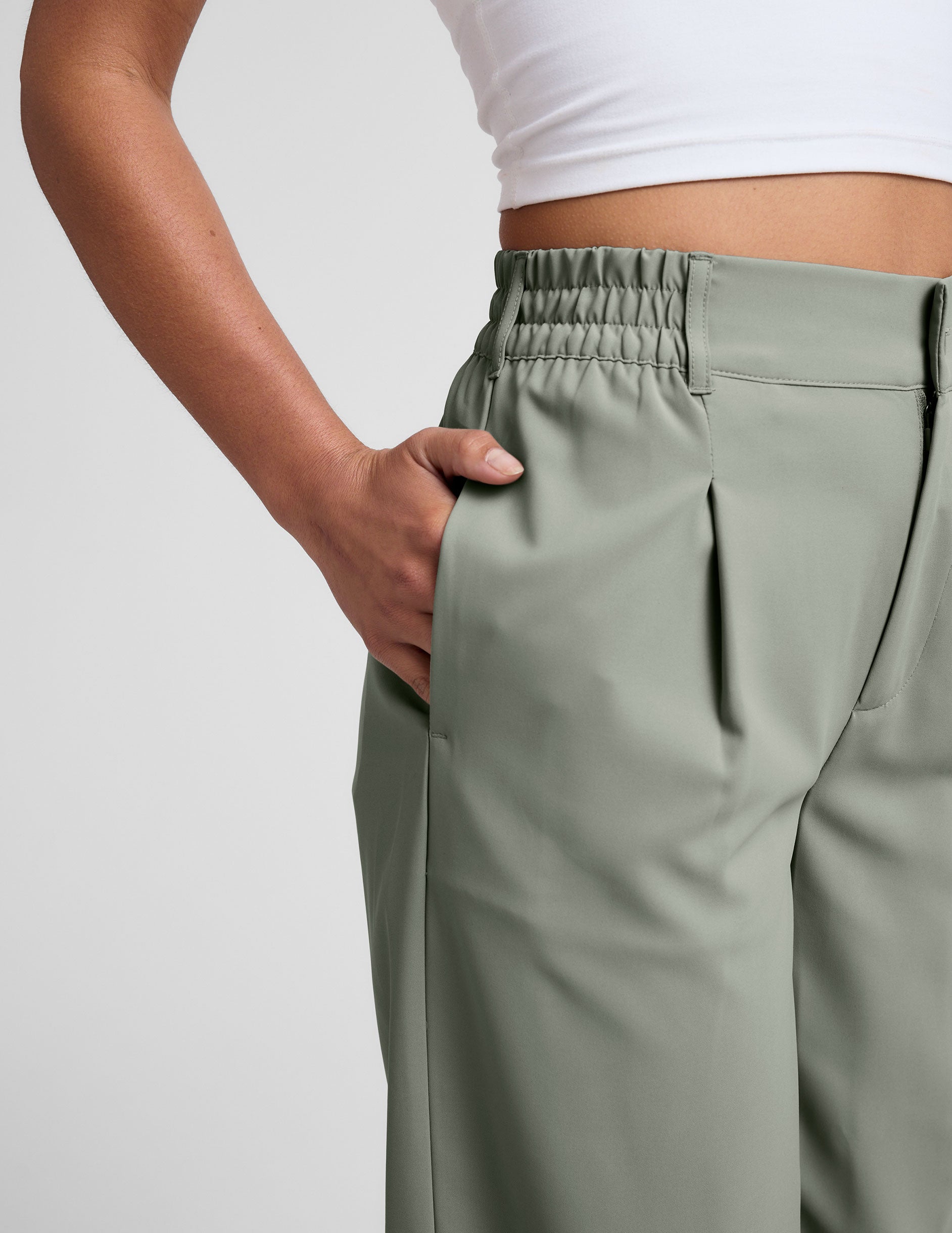 green mid-rise trouser pants with pockets. 