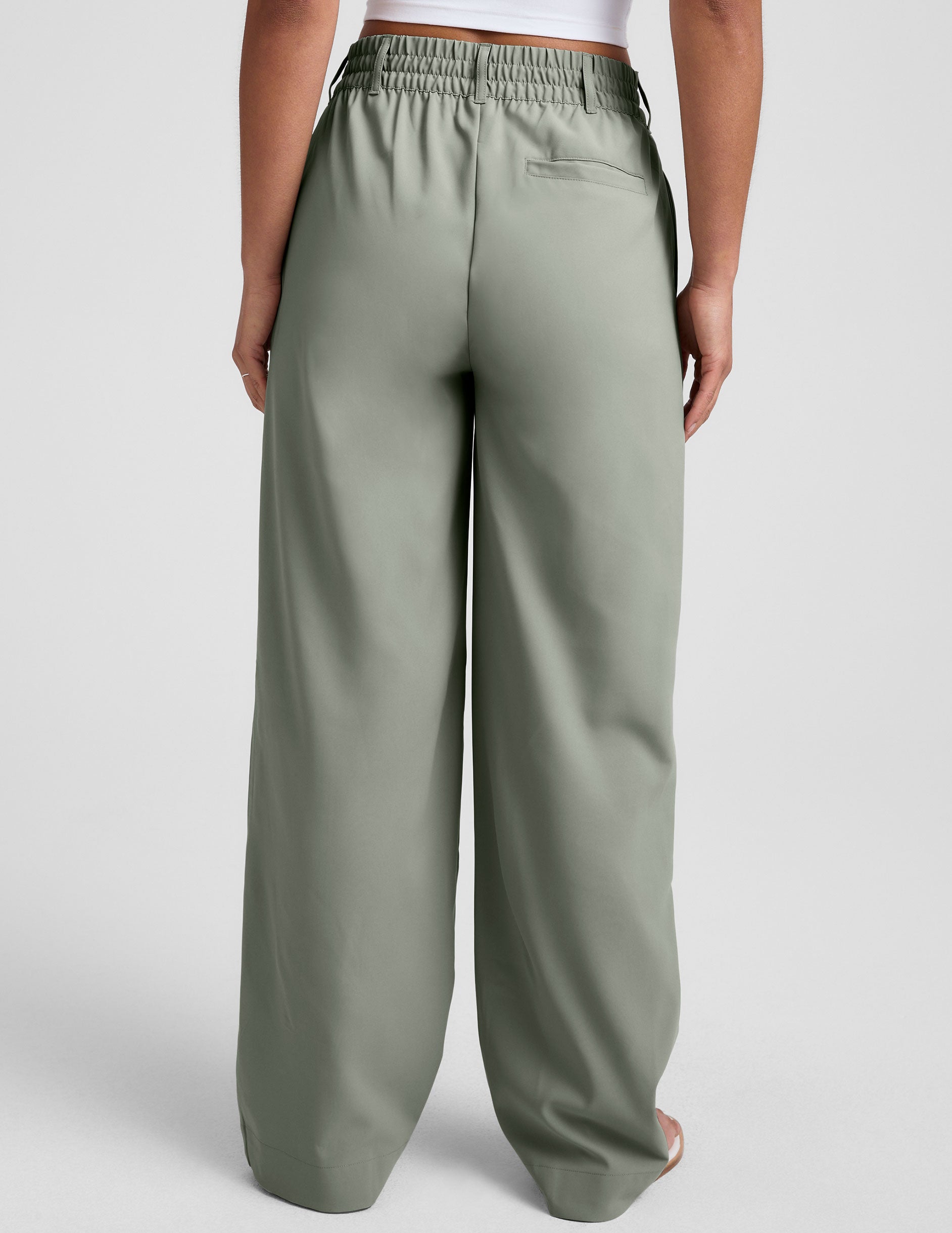 green mid-rise trouser pants with pockets. 