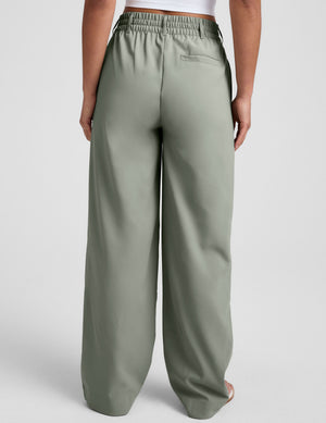 green mid-rise trouser pants with pockets. 