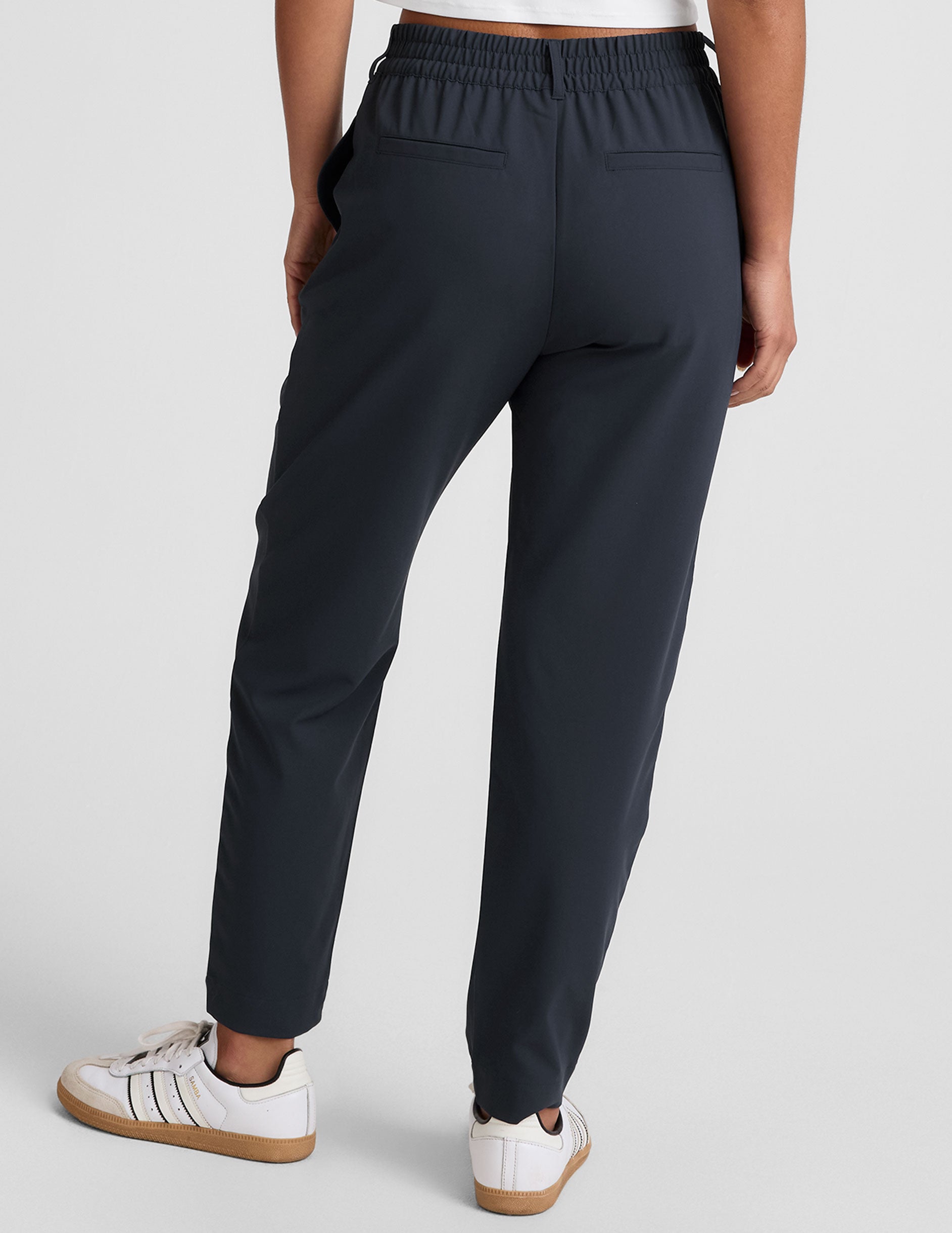 blue trouser style pant with a tapered ankle and pockets. 