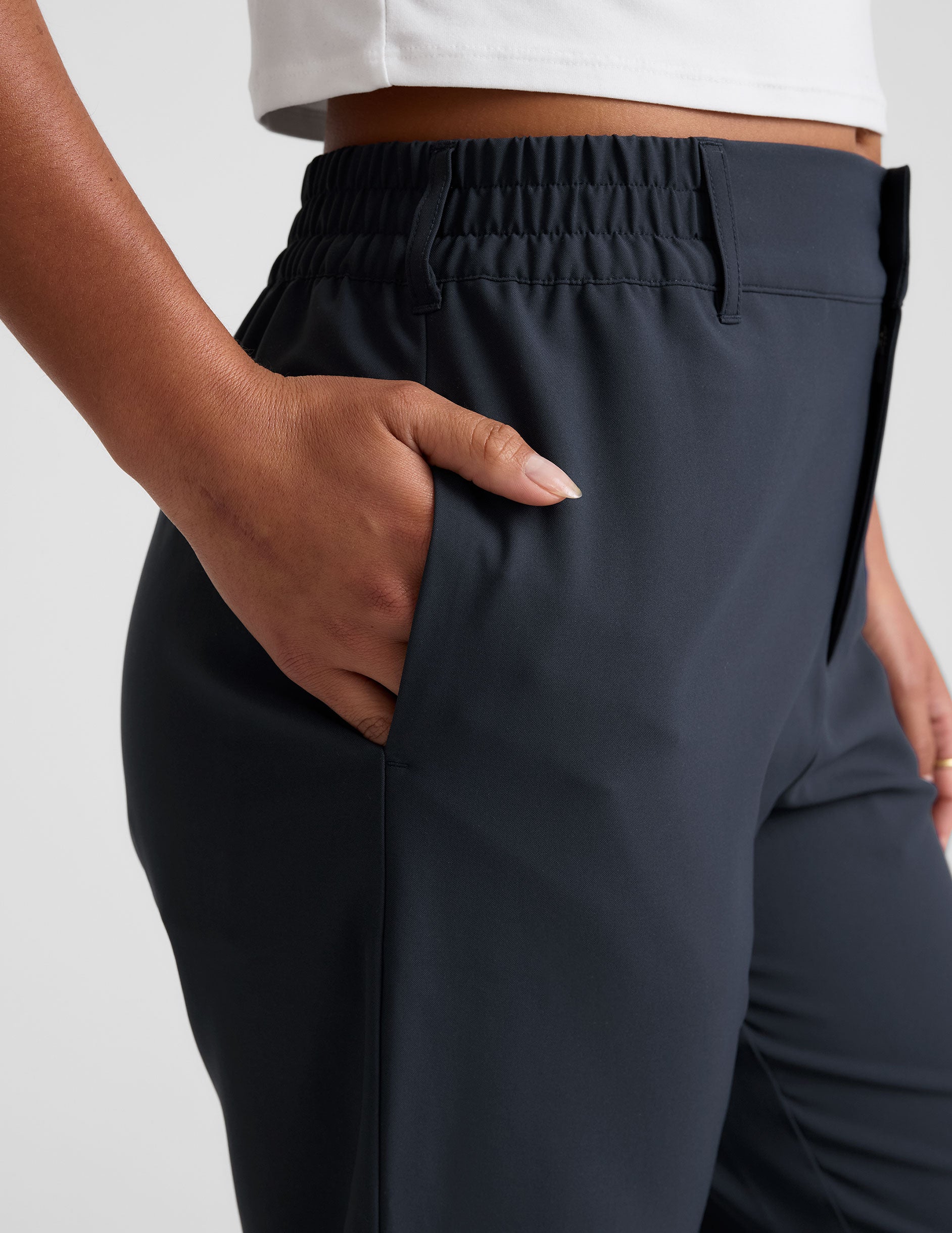 blue trouser style pant with a tapered ankle and pockets. 