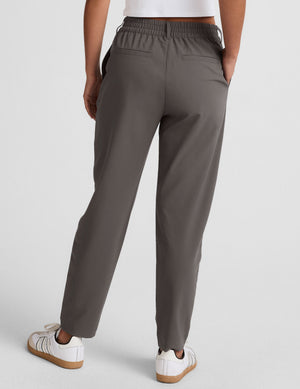 Back view of the gray Status Tapered Pant featuring a mid-rise elasticated waistband, belt loops, and a tapered leg.