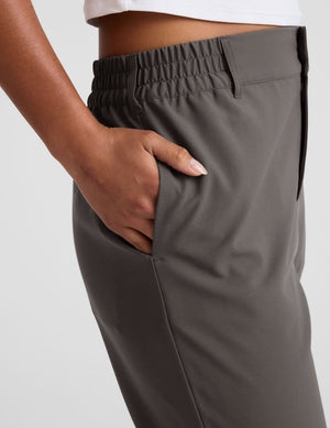 Side view of the gray Status Tapered Pant featuring an elasticated waistband, belt loops, and side seam pocket.