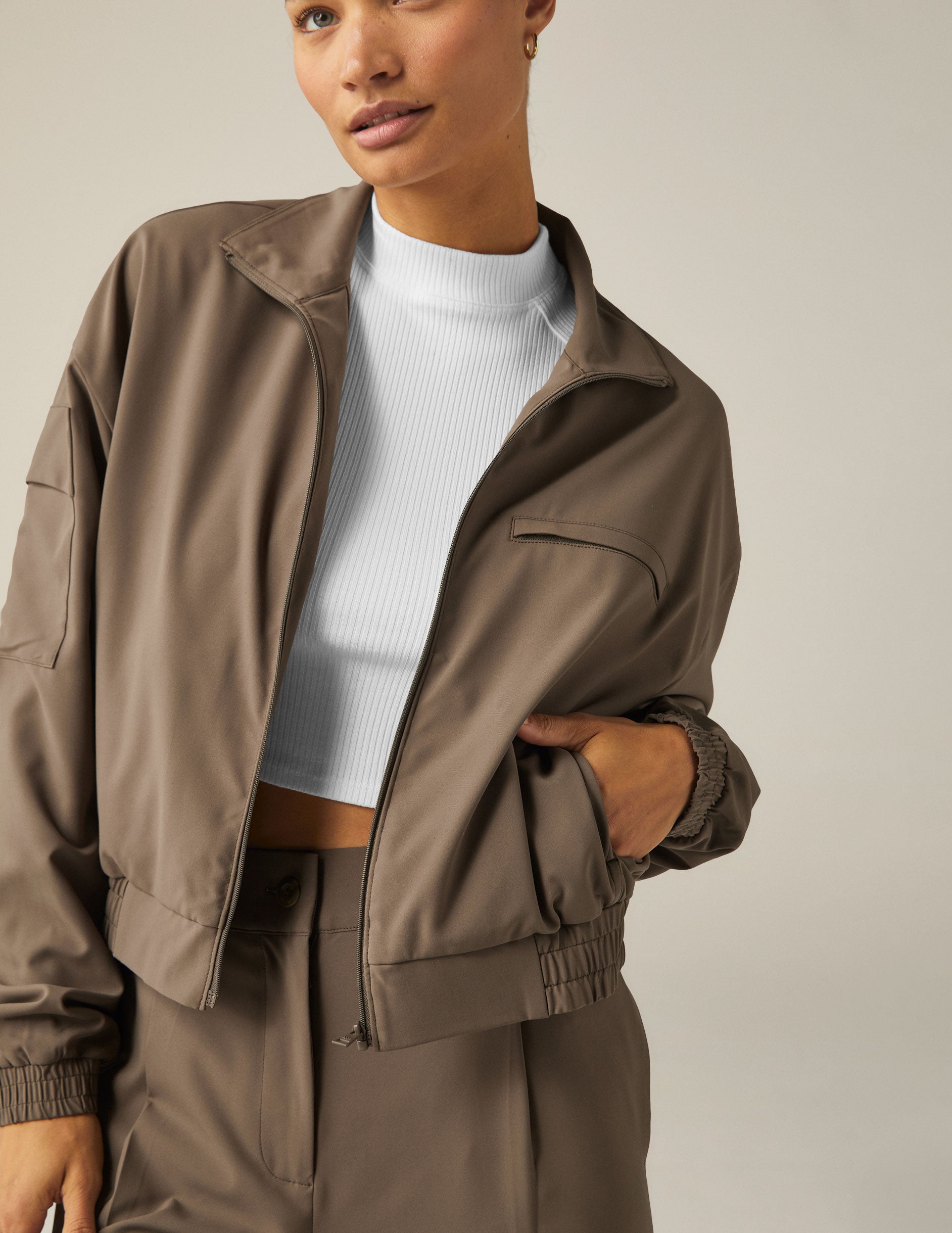 brown zip-up jetstretch woven jacket with a collar and pockets. 