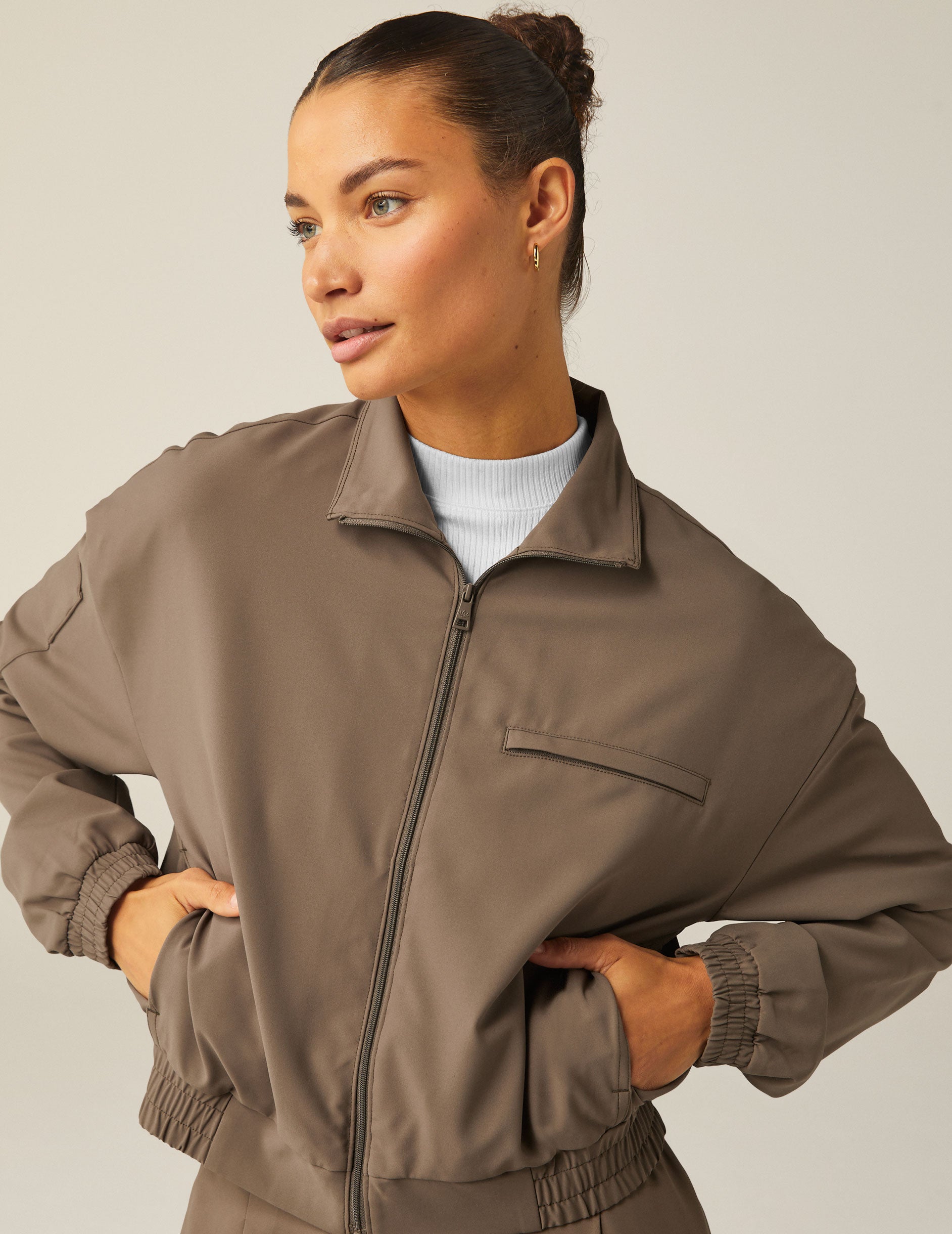 brown zip-up jetstretch woven jacket with a collar and pockets. 