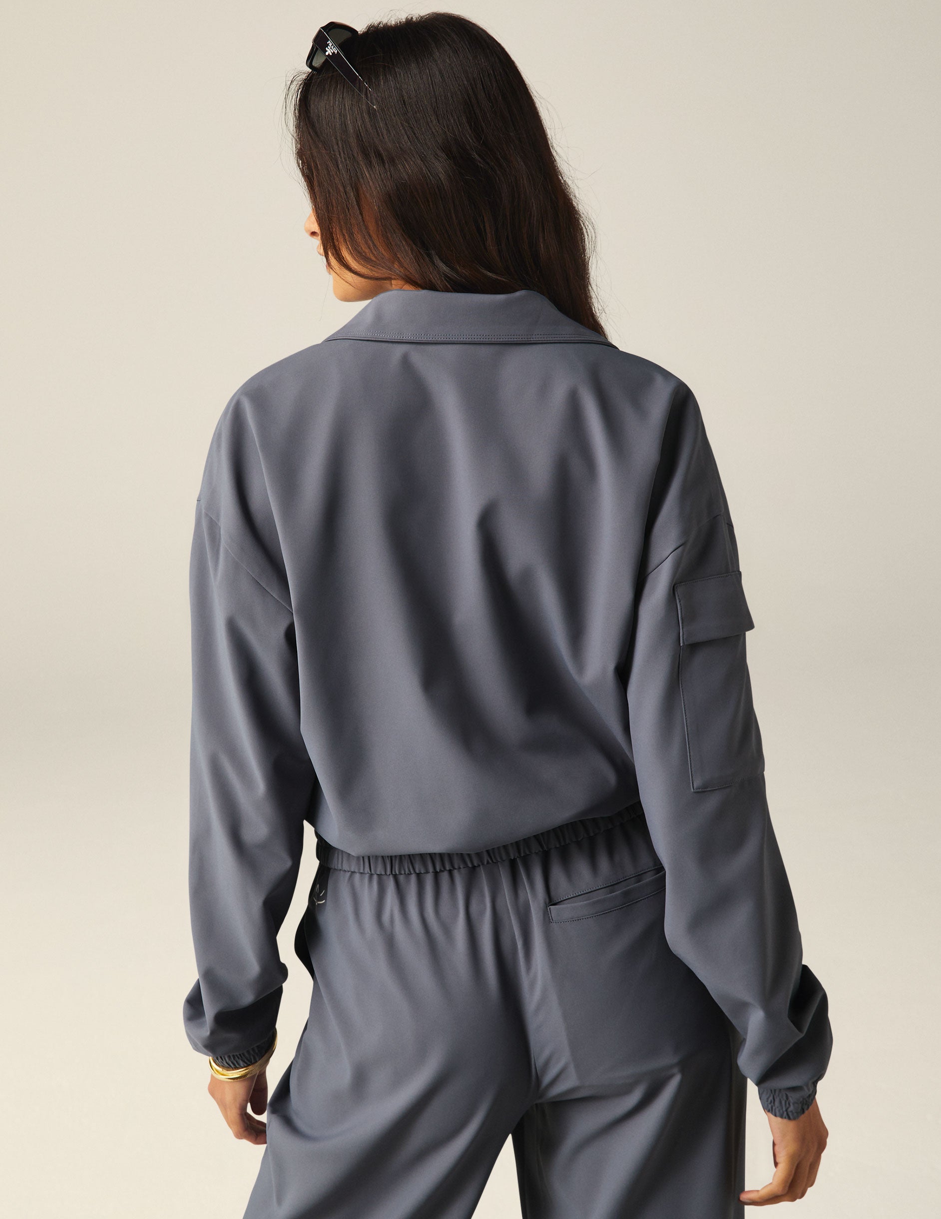 blue zip-up jetstretch woven jacket with pockets and a collar. 