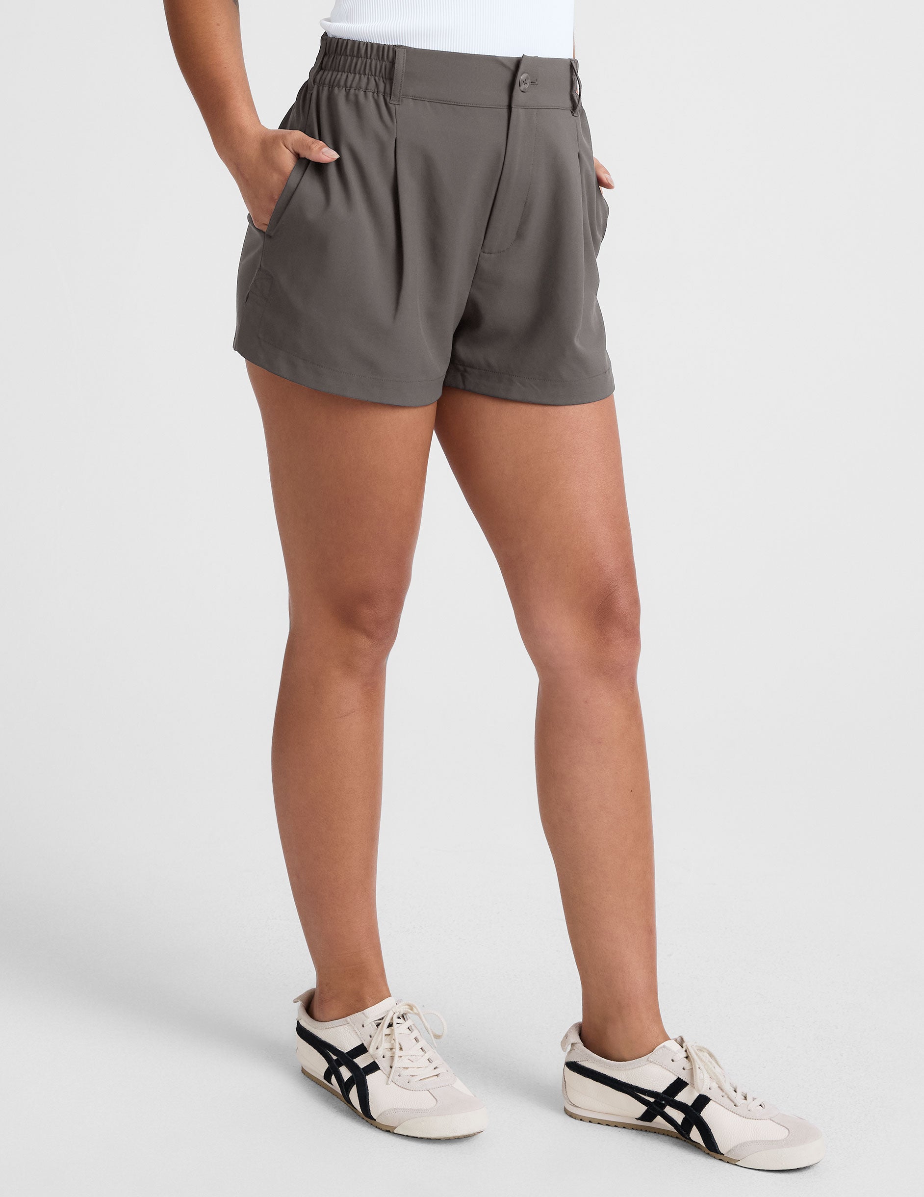 grey mid rise shorts with pockets and an elastic waistband with belt loops. 