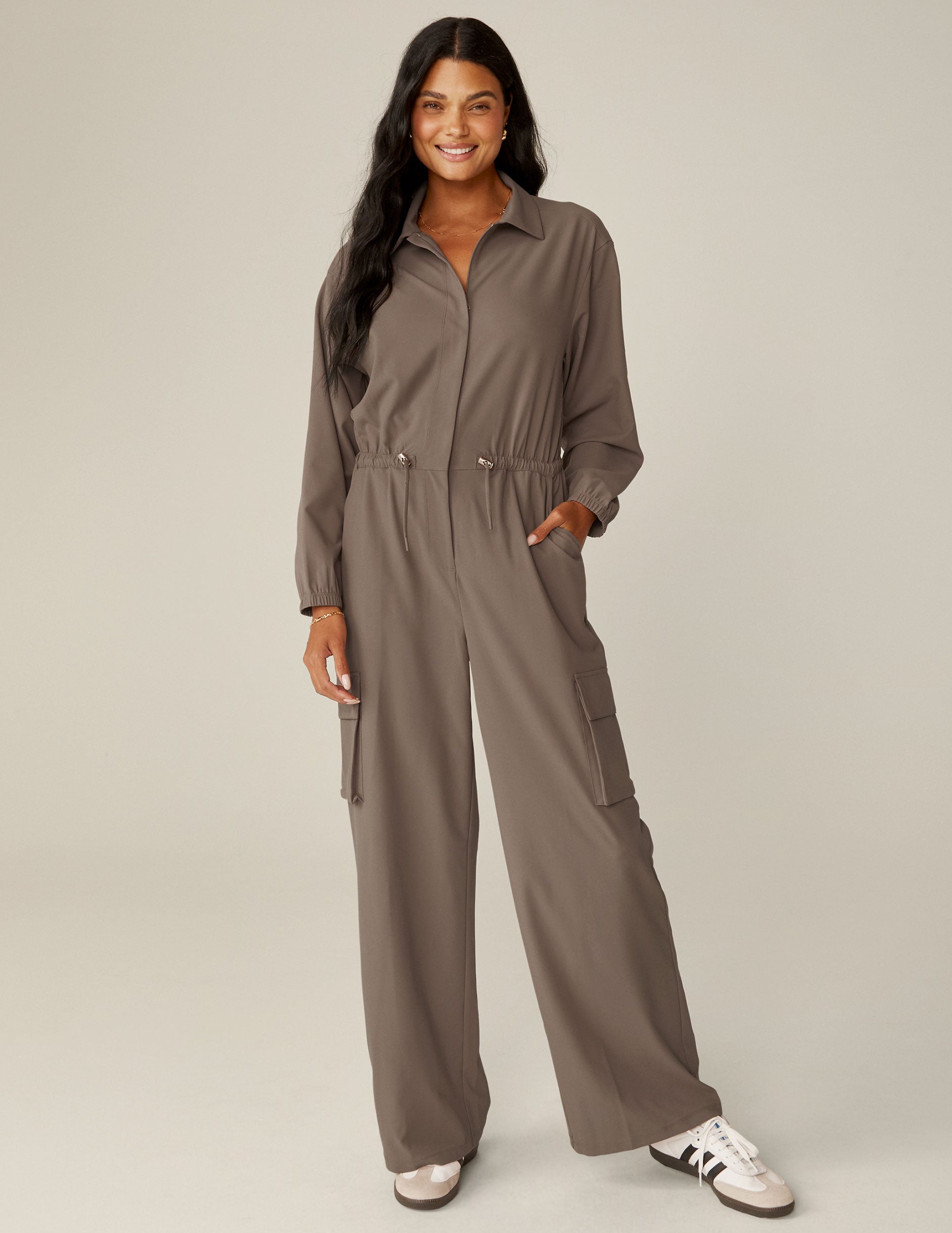 brown long sleeve cargo style jumpsuit with pockets. 