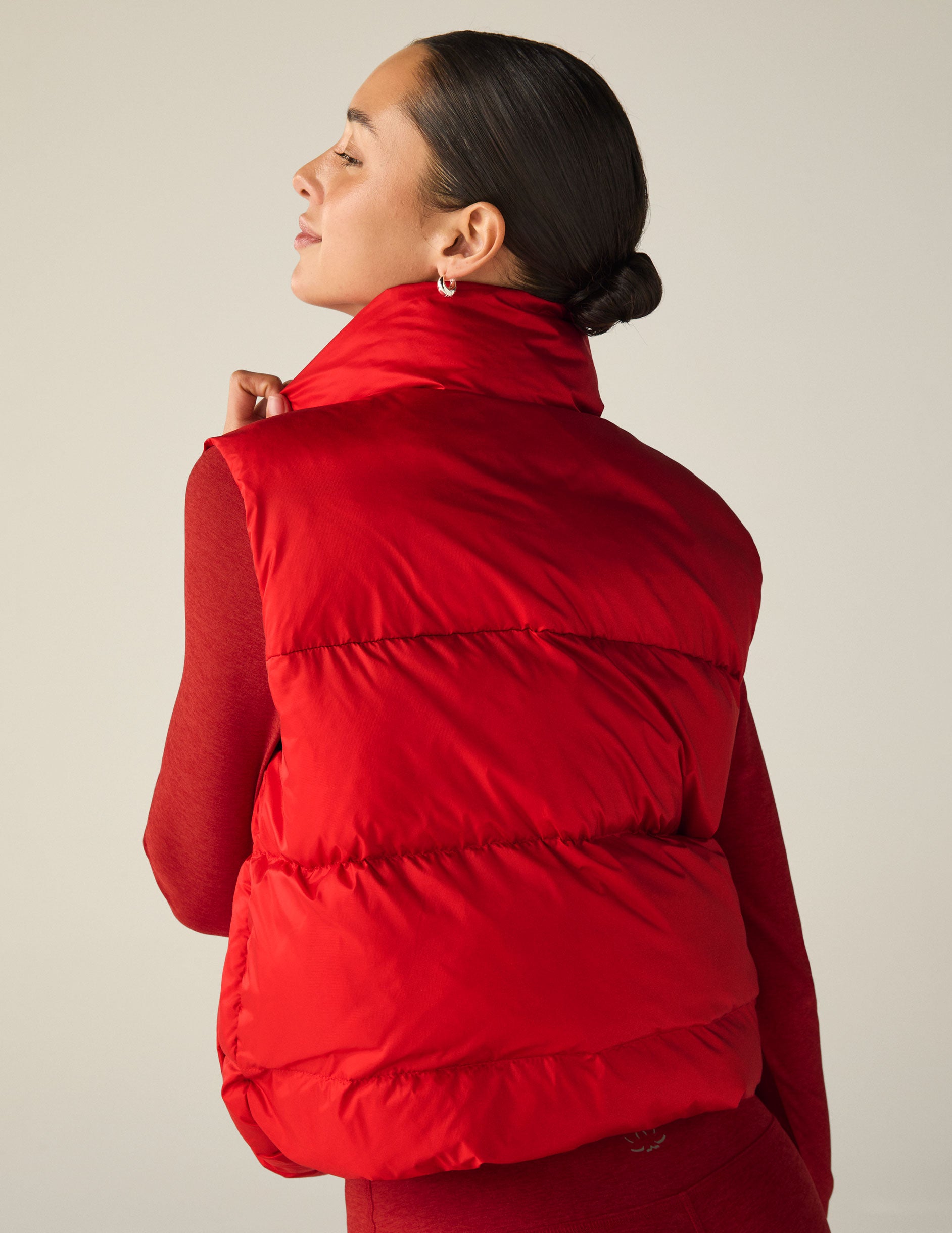 red button-up puffer vest with pockets. 