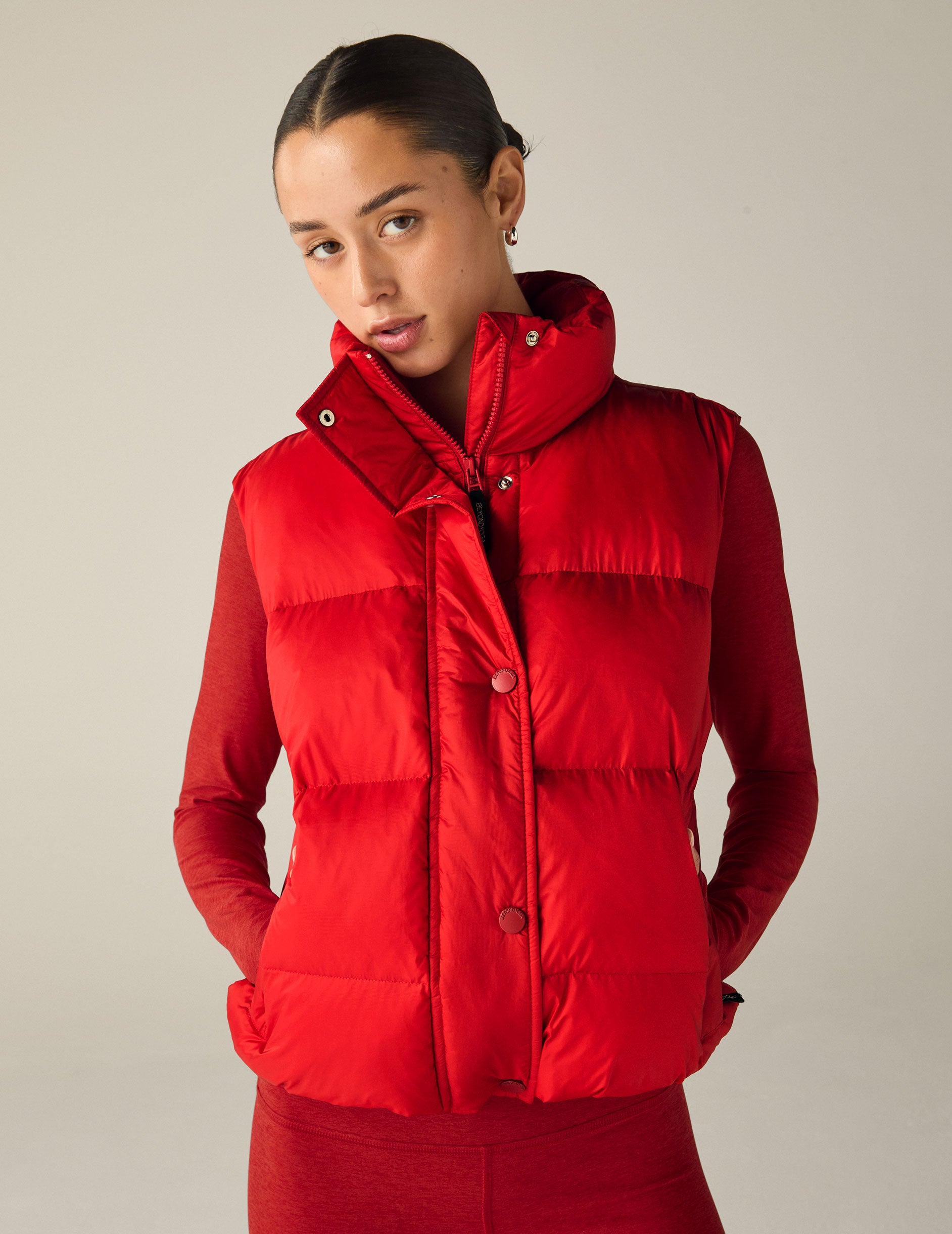 red button-up puffer vest with pockets. 