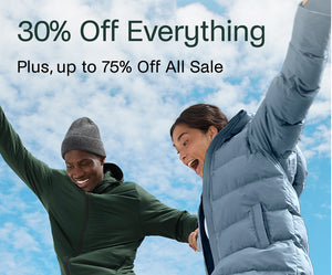 Two people in winter clothing with a promotional text overlay against a blue sky.