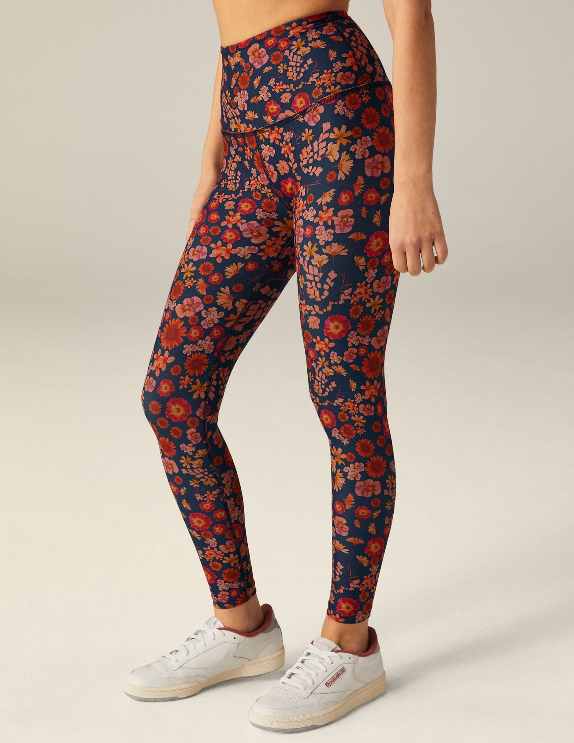 blue high-waisted midi leggings with a retro floral print. 