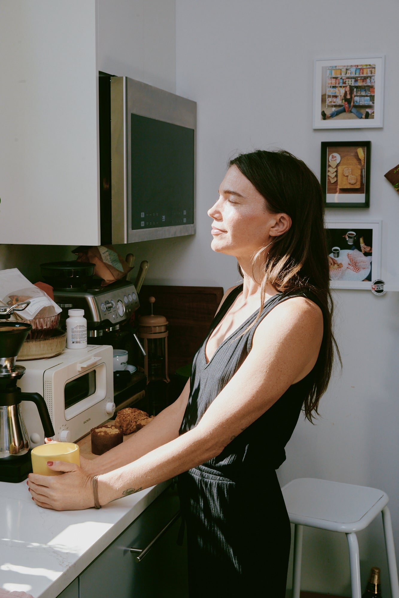 Rachel wearing the Jetsetter jumpsuit in her kitchen