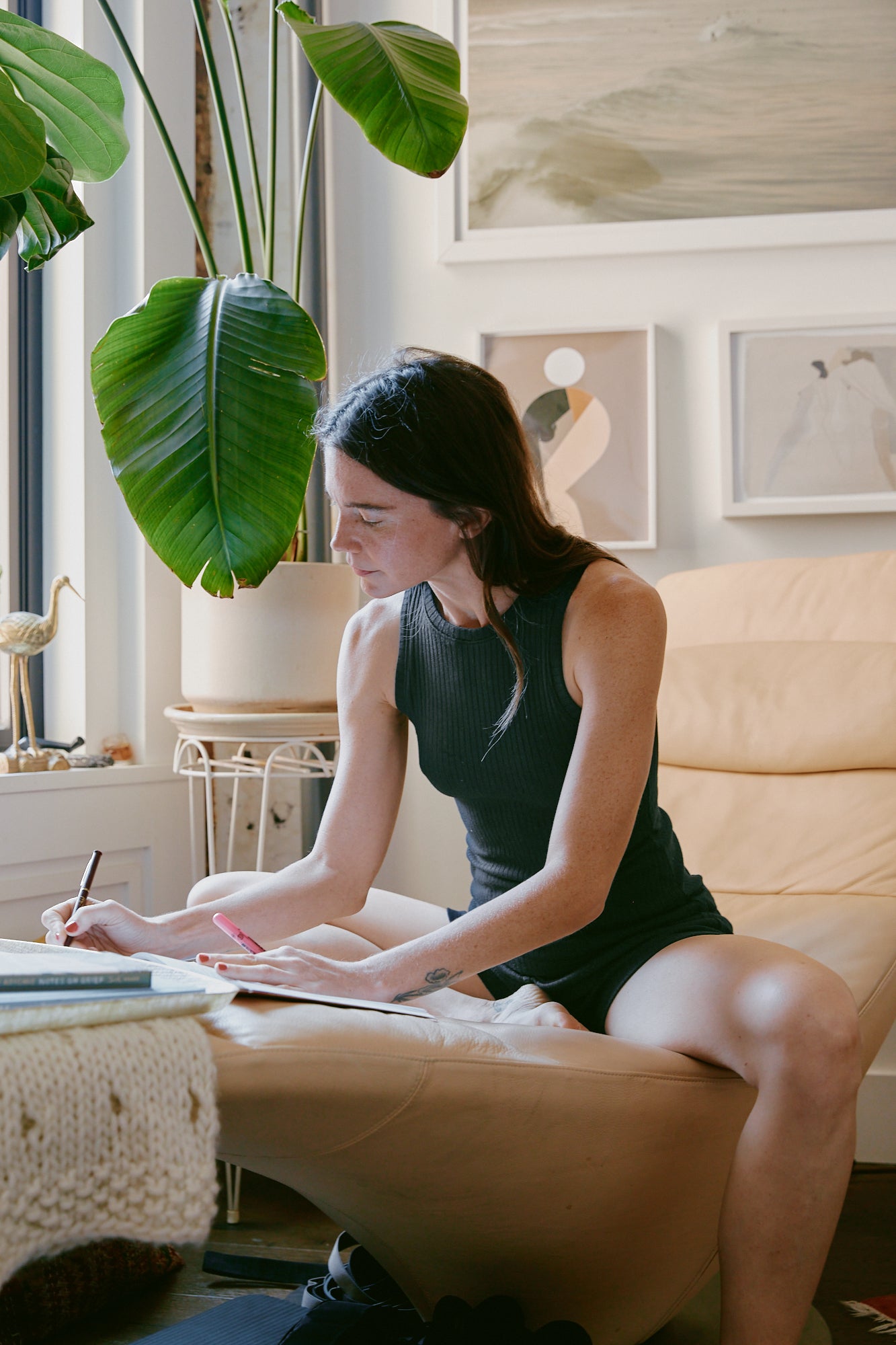 Rachel journaling in her home