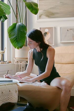 Rachel journaling in her home