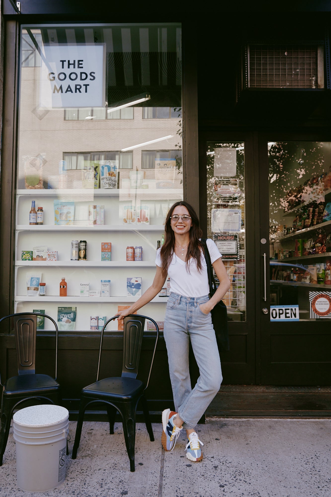 Rachel outside of The Goodsmart in jeans and white tee