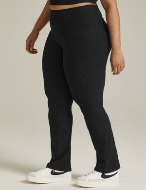 High-waisted black Spacedye Practice High Waisted Pant with a wide waistband and bootcut leg opening on a model.