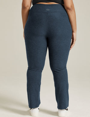 Rear view of a person wearing Spacedye Practice High Waisted Pants in Nocturnal Navy, featuring a marled texture and snug fit.