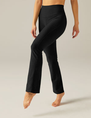 Model wearing black Spacedye Practice High Waisted Pants with a bootcut leg, high rise waistband, and marled fabric texture.