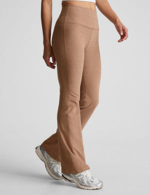 Woman wearing Brown Spacedye™ Practice High Waisted Bootcut Pant paired with a white top and silver sneakers.