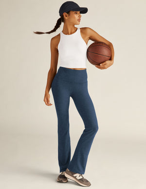 Navy marled Spacedye Practice High Waisted Pant with a bootcut leg, shown on a model in a white top holding a basketball.