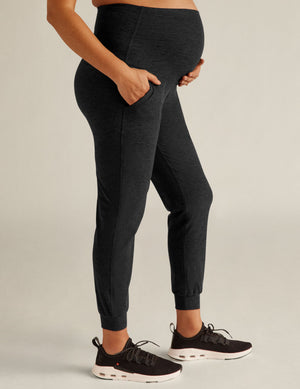 Spacedye Beyond the Bump Maternity Midi Jogger in marled black with a high waist, side pocket, and tapered banded cuffs.