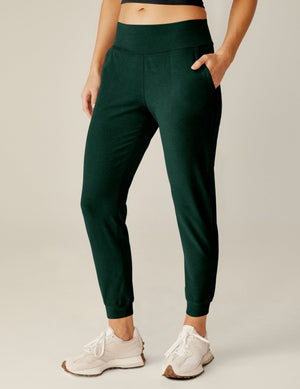 Emerald green Spacedye Midi Jogger with a wide waistband and tapered legs, shown on a model with white sneakers.