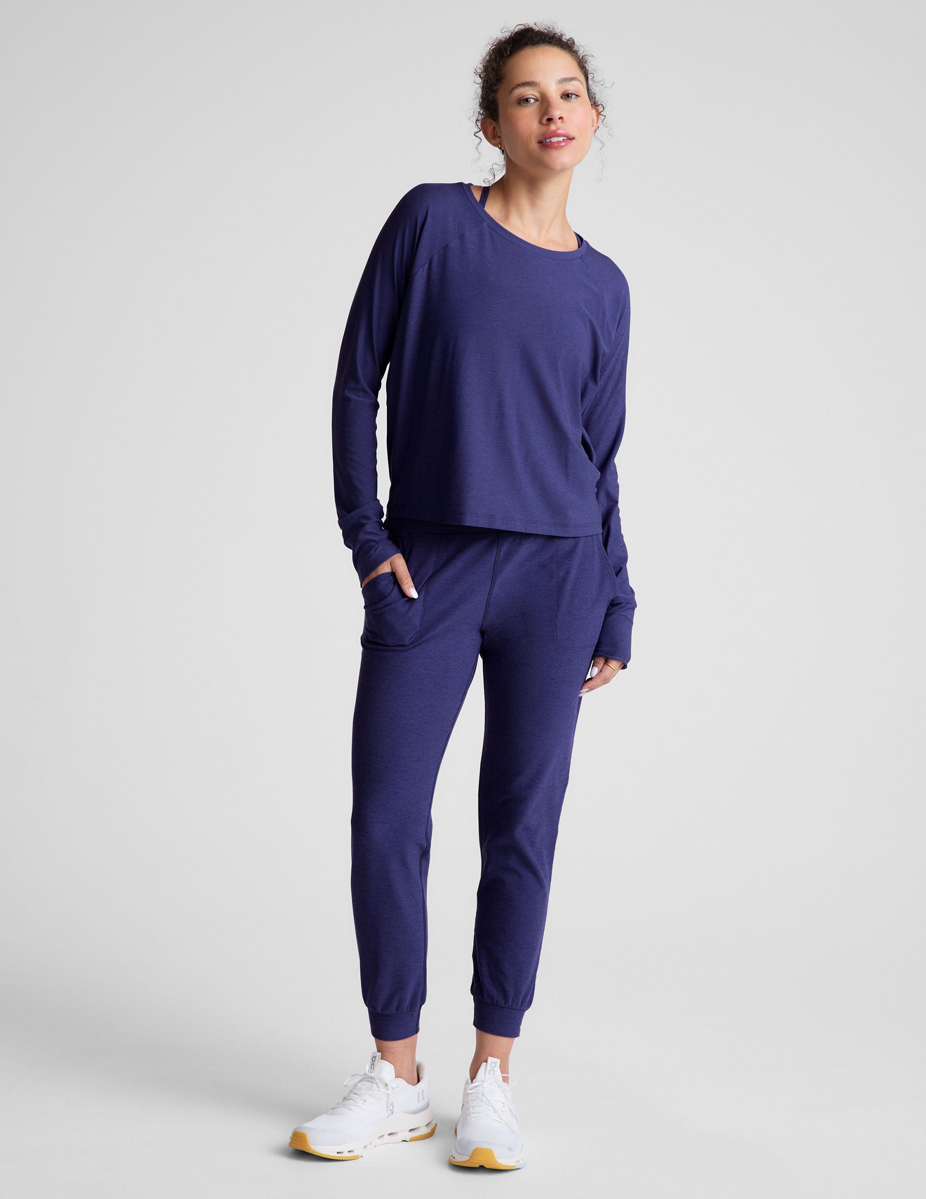 blue high-waisted midi length joggers with pockets. 