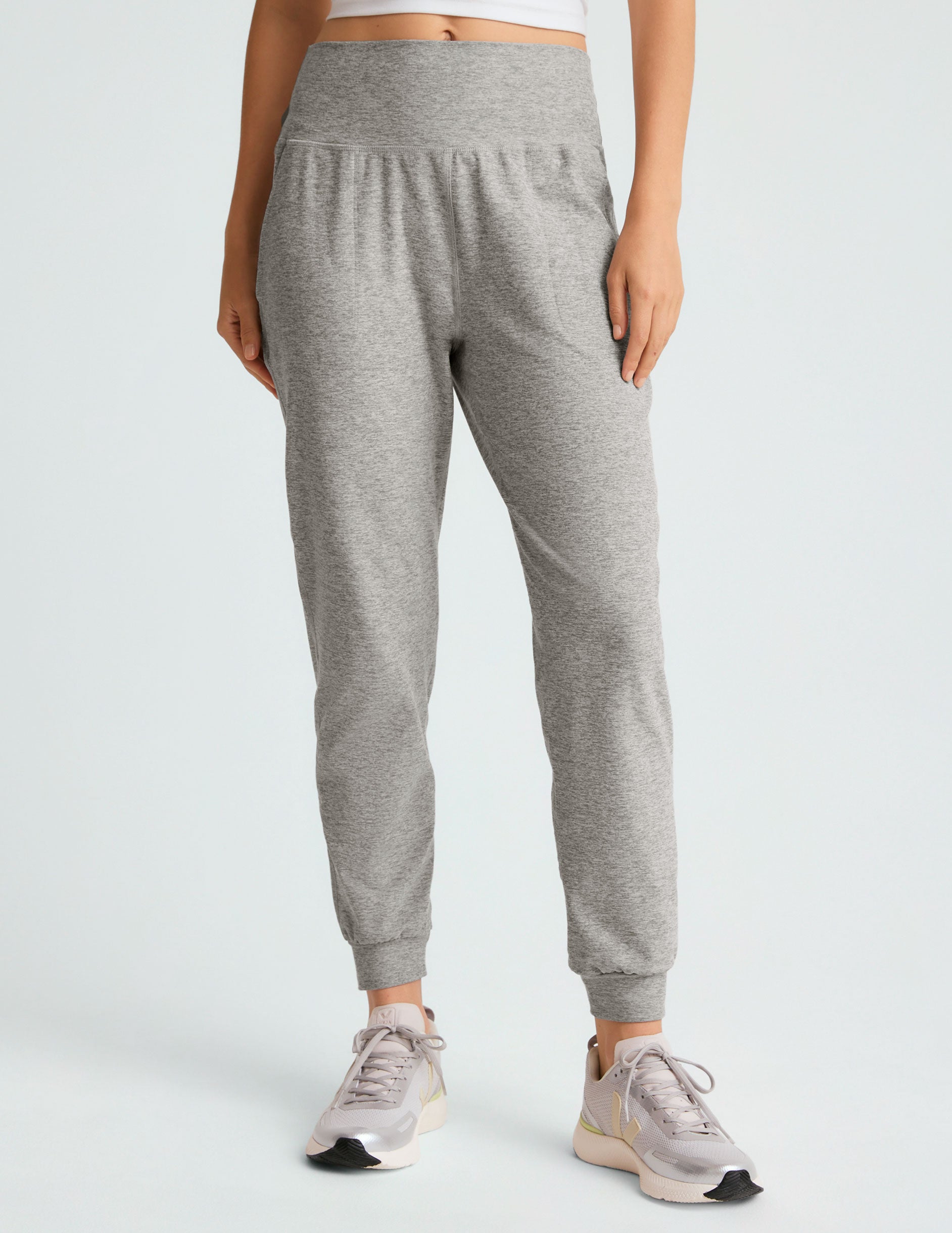 grey high-waisted midi length jogger pants with pockets.