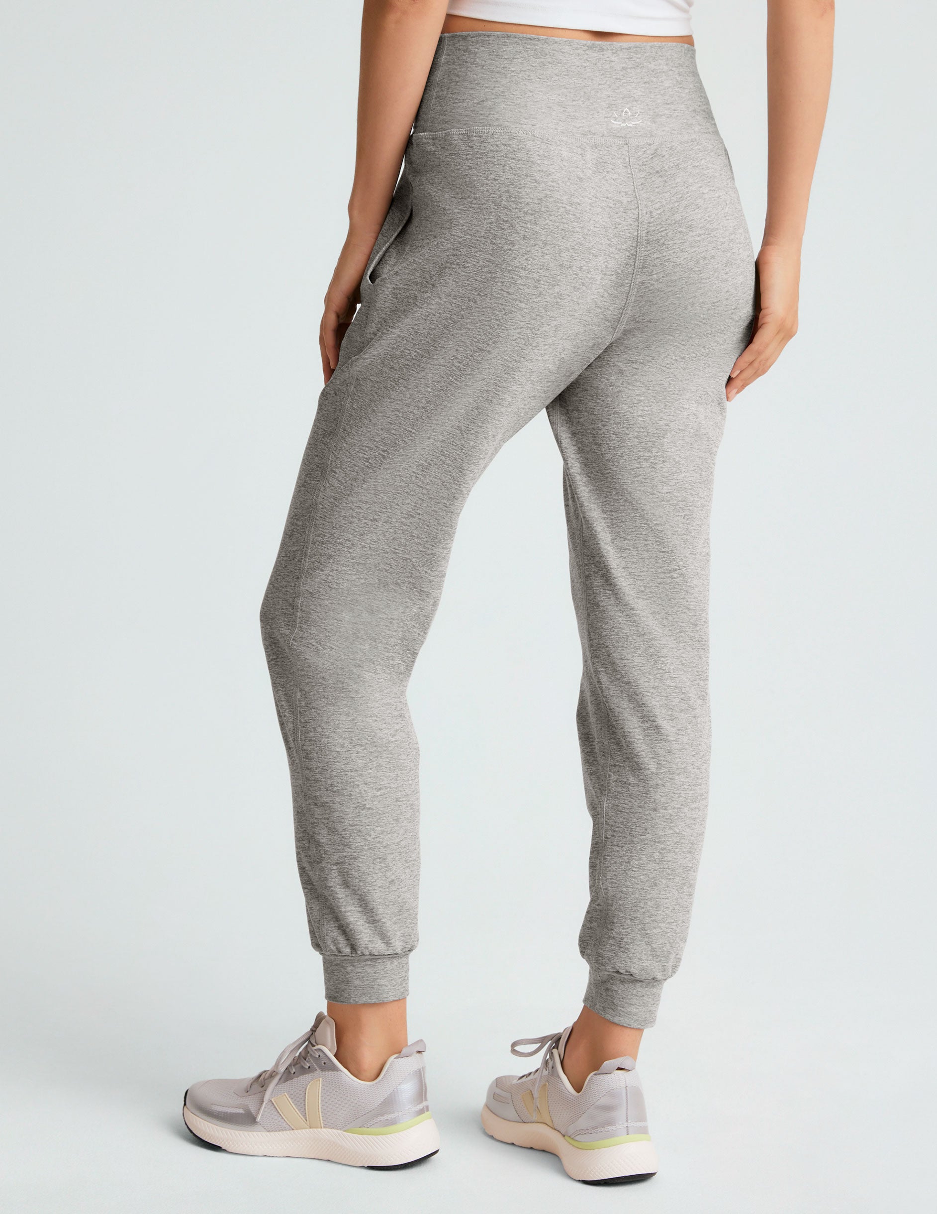 grey high-waisted midi length jogger pants with pockets.