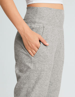 grey high-waisted midi length jogger pants with pockets.