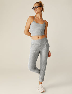 Woman wearing Spacedye Midi Jogger in silver mist with a matching crop tank, featuring a tapered leg and cuffed ankles.
