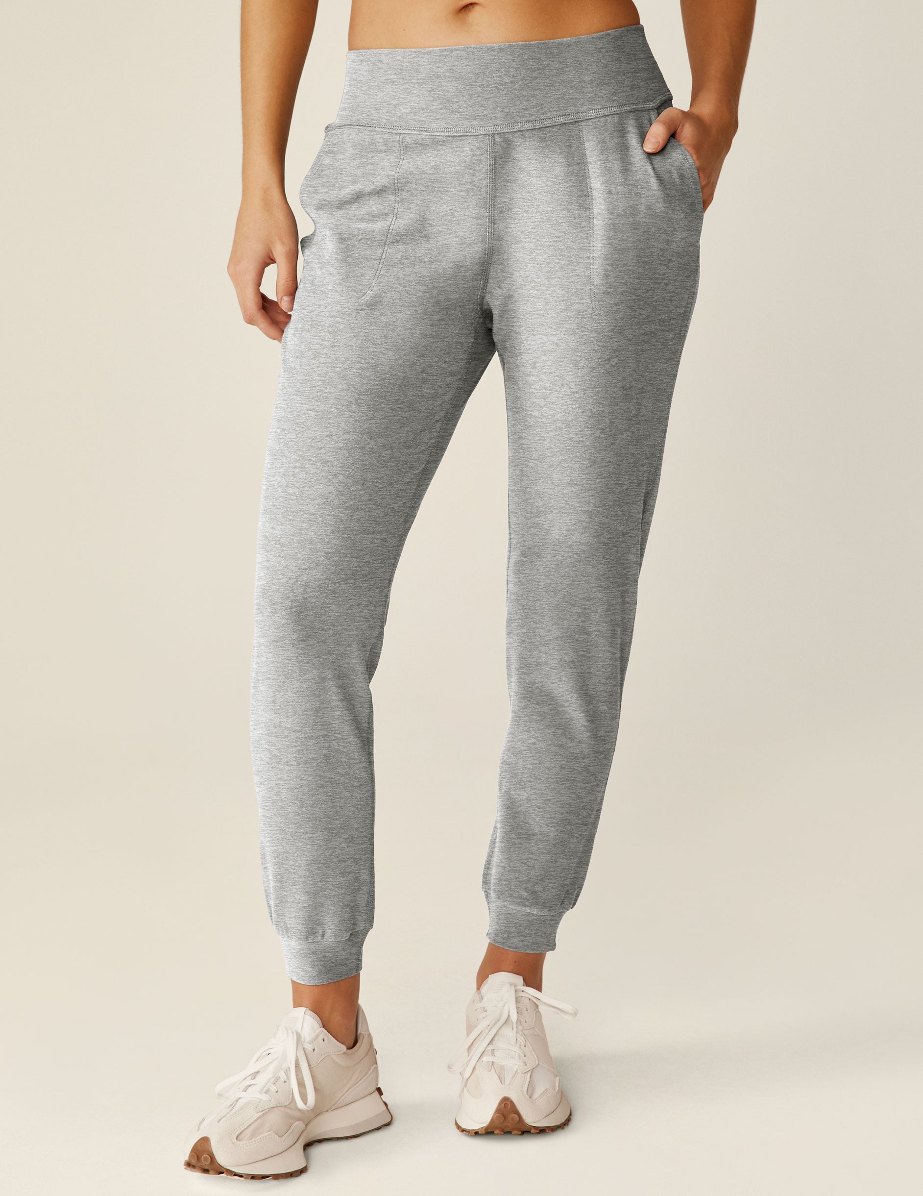 grey high-waisted midi length jogger pants with pockets. 