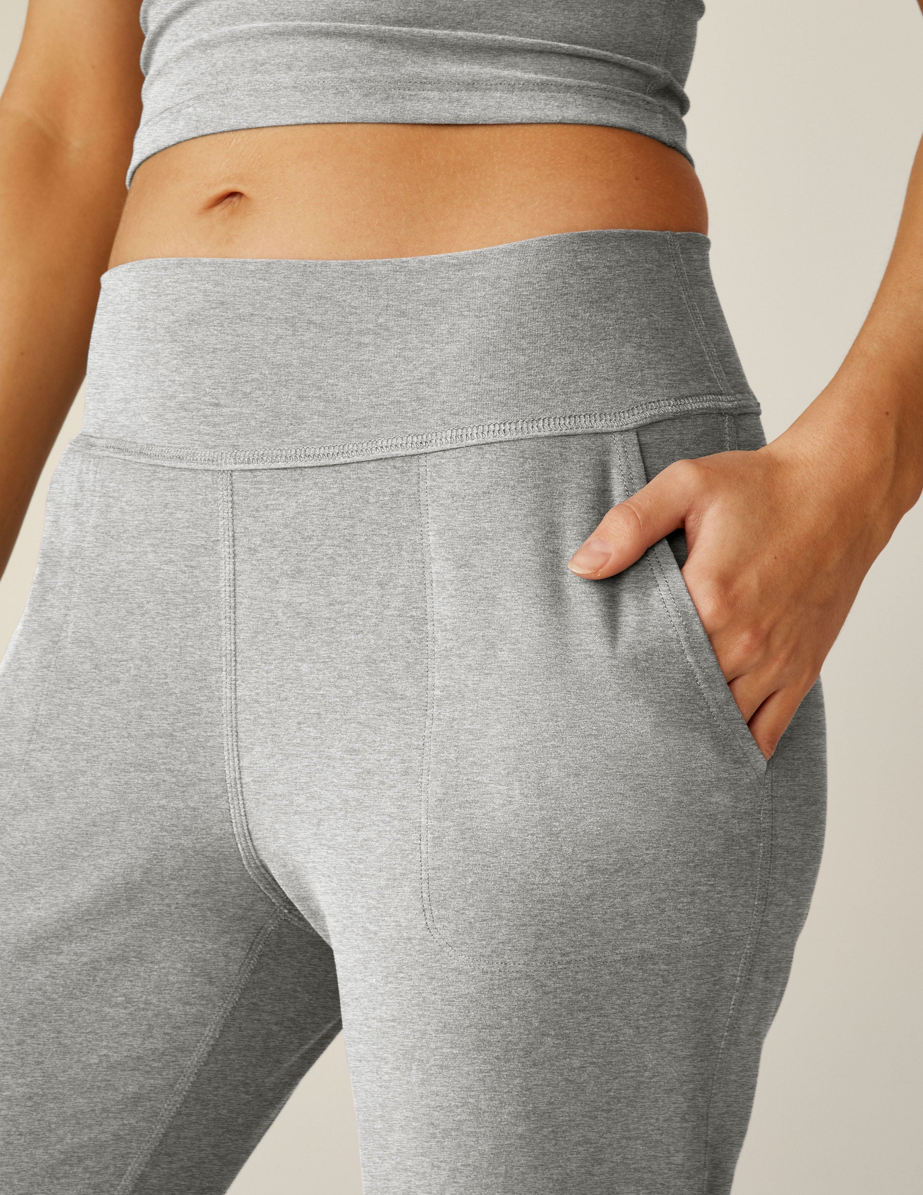 grey high-waisted midi length jogger pants with pockets. 