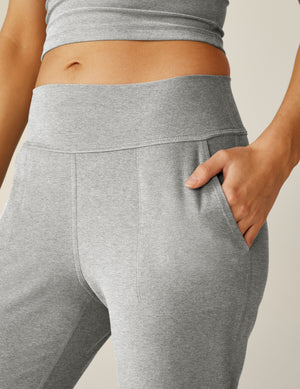 Close-up of Spacedye Midi Jogger in silver mist gray, showing the wide waistband and a hand resting in a side slant pocket.
