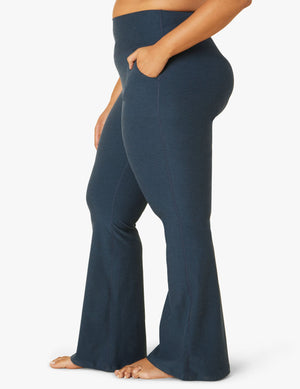 Side view of navy Spacedye All Day Flare High Waisted Pant showing the snug fit, hip pocket, and flared bell bottom legs.