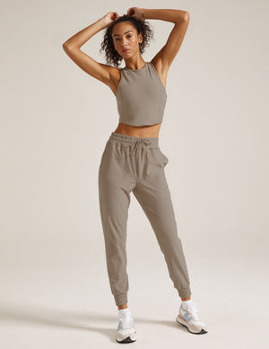Woman wearing Gray Spacedye™ Commuter Midi Jogger paired with a matching cropped tank top and white sneakers.