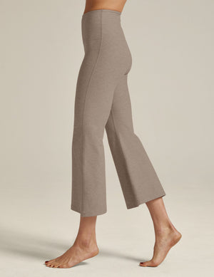 Side view of a person wearing beige Spacedye Retro Cropped Pant with a high waistband and flared ankle-length legs.