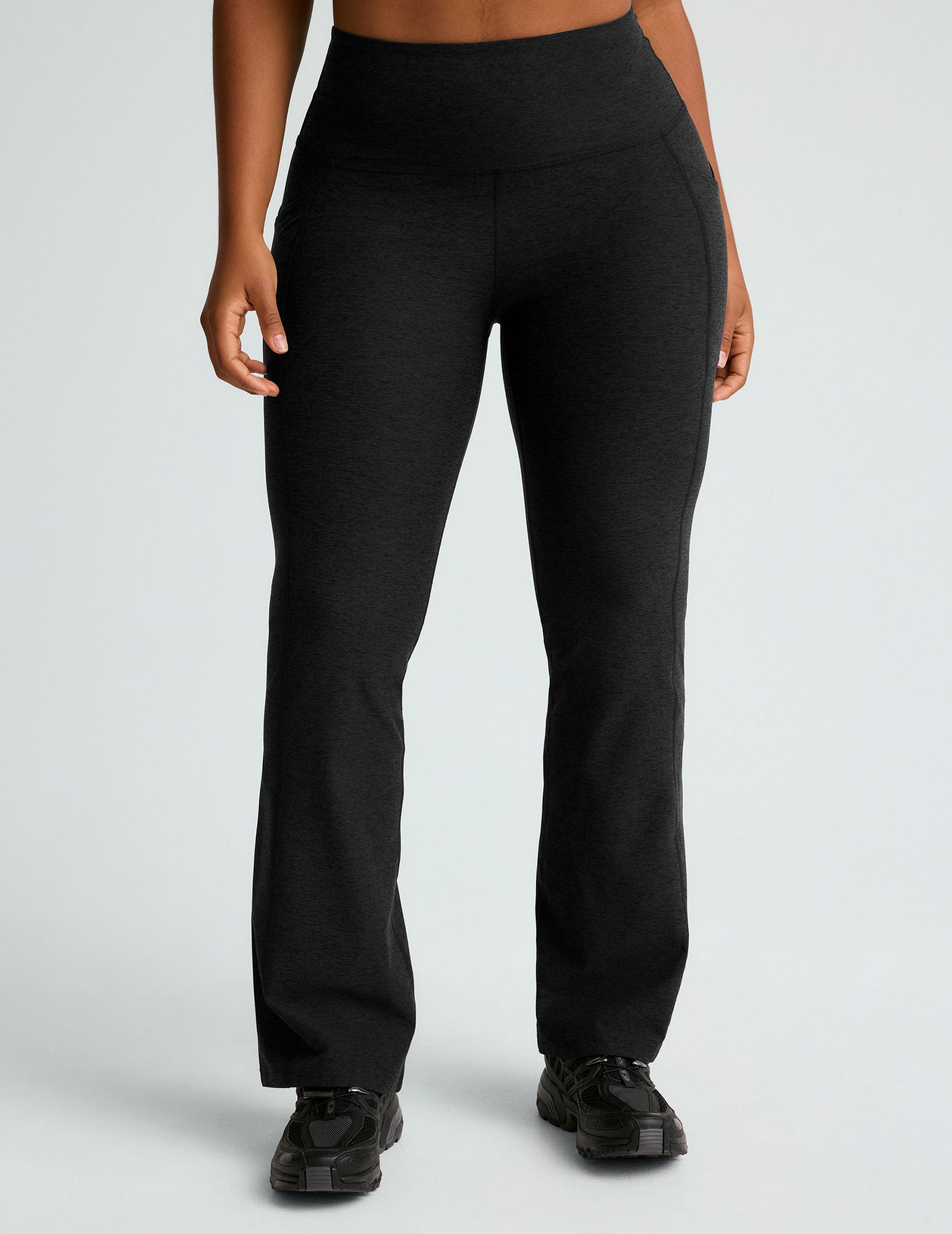 black high-waisted flare leggings with front side pockets. 