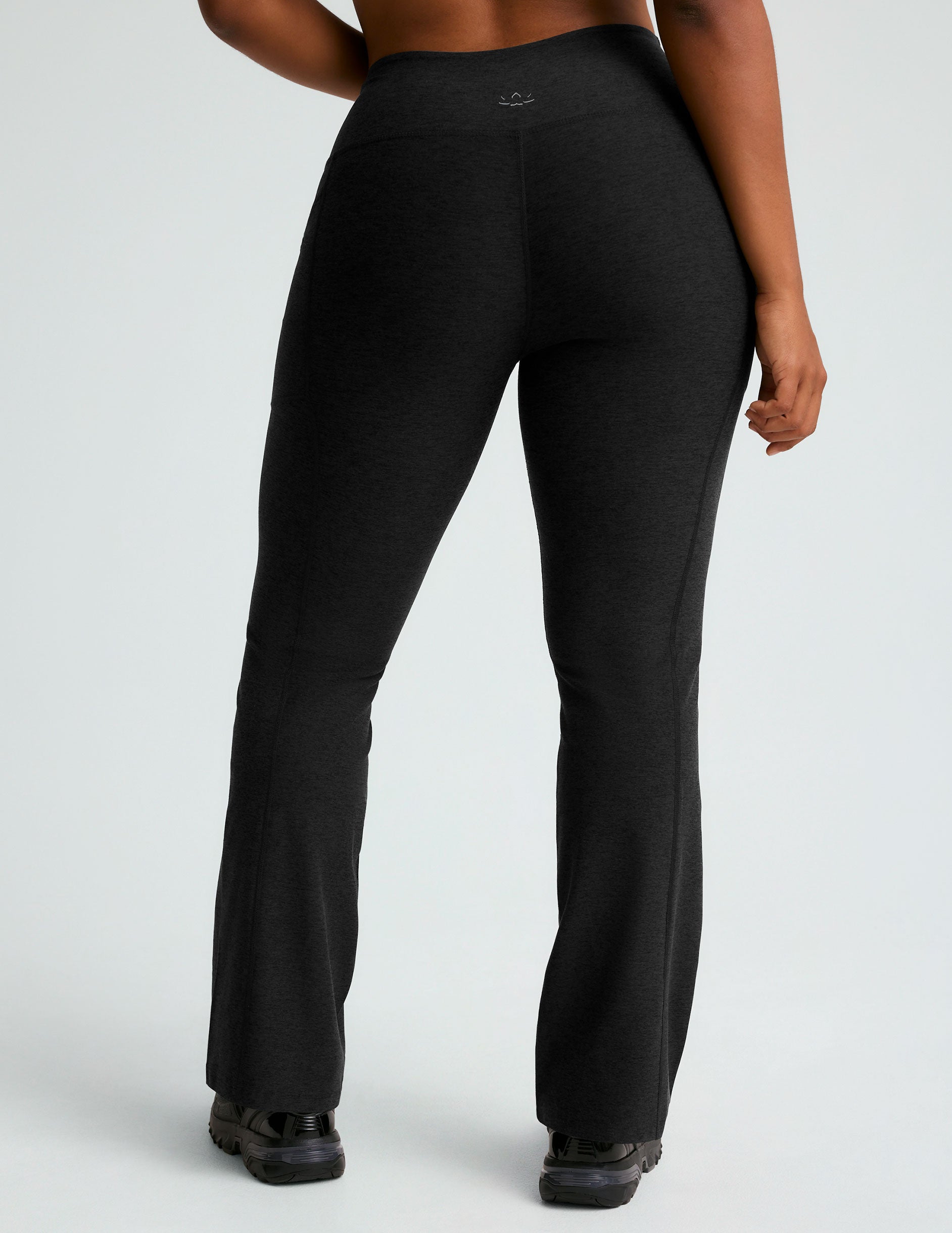 black high-waisted flare leggings with front side pockets. 