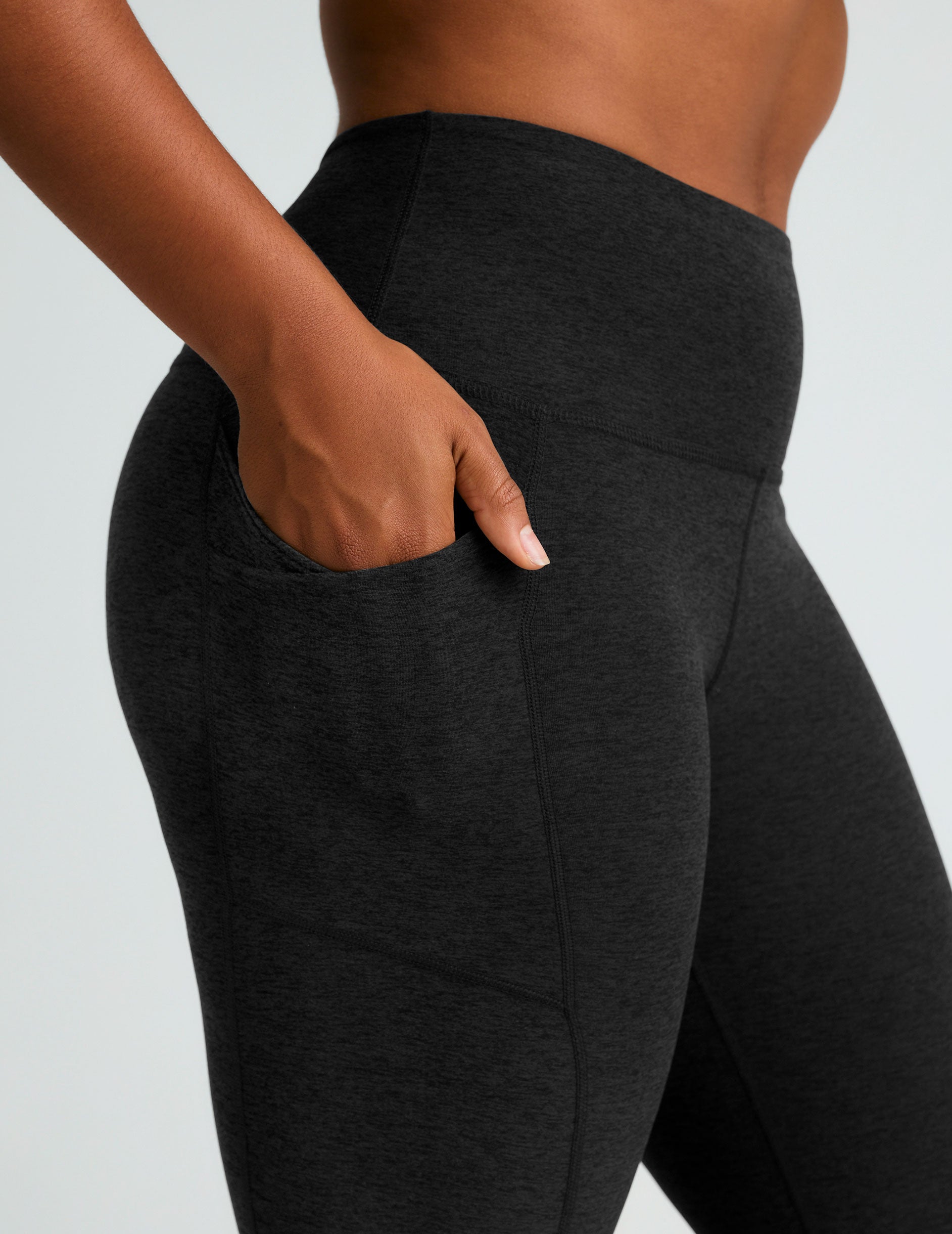 black high-waisted flare leggings with front side pockets. 