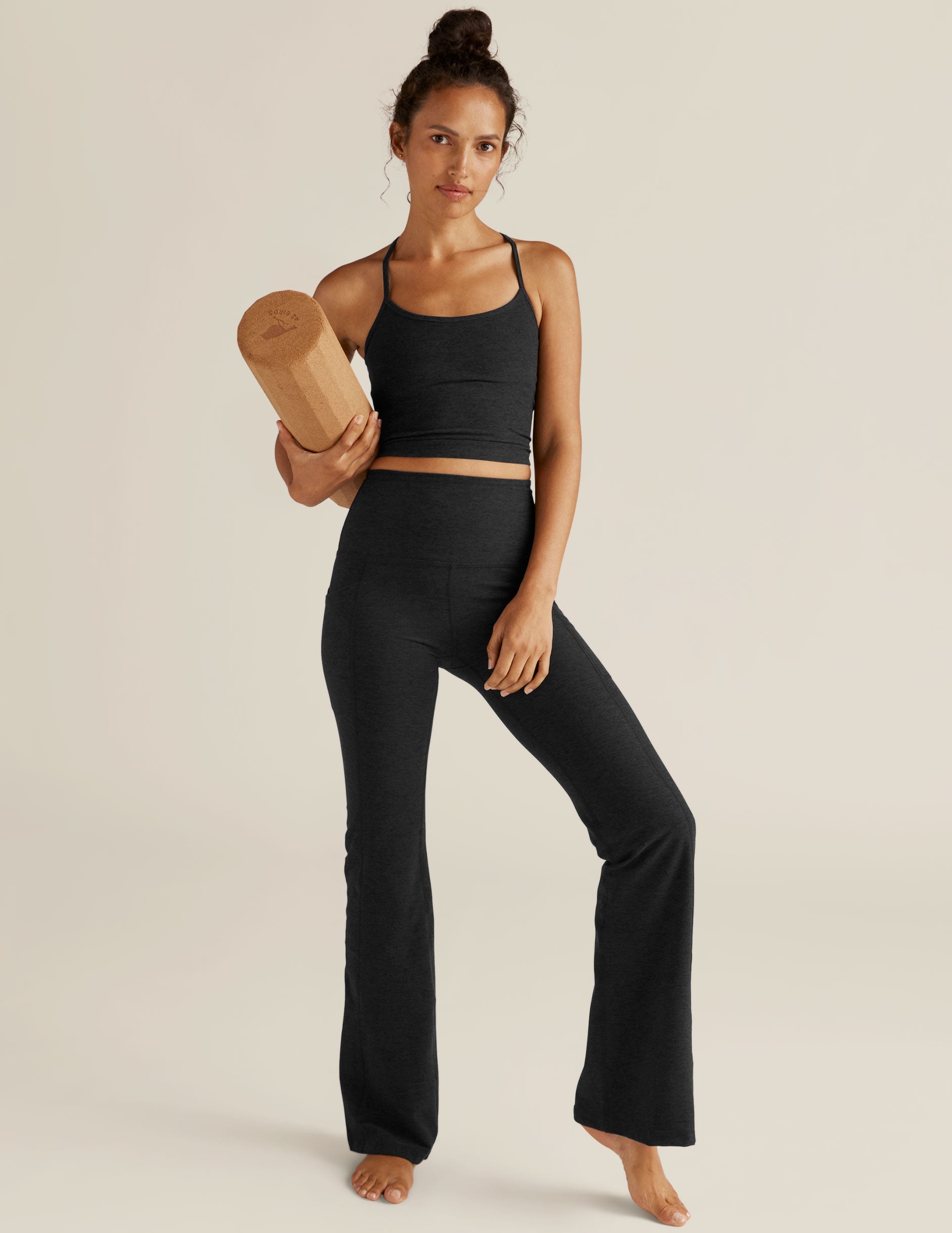 black high-waisted flare leggings with front side pockets. 