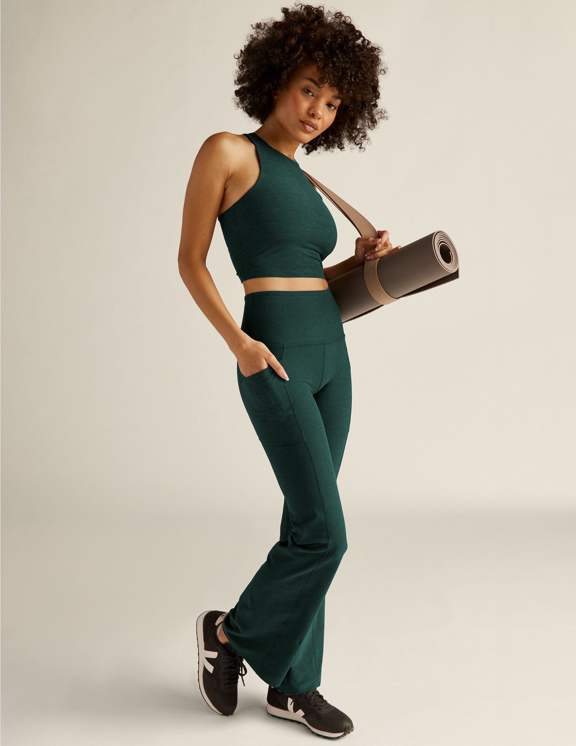 green high-waisted bootcut leggings with front side pockets. 